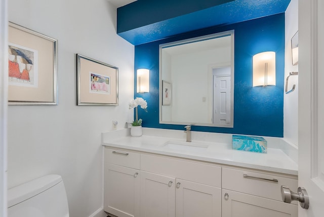 bathroom featuring toilet and vanity