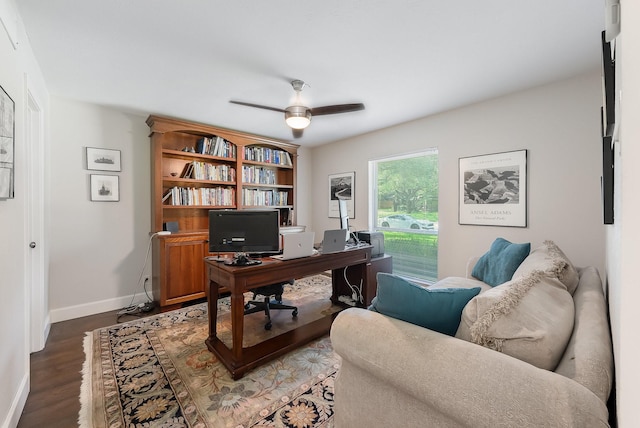 office area featuring a ceiling fan, dark wood-type flooring, and baseboards