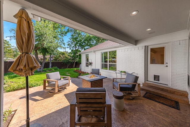 view of patio / terrace with an outdoor fire pit, fence, and entry steps