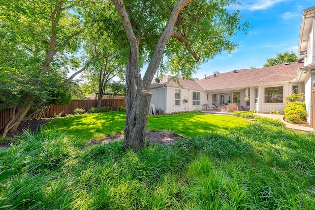 view of yard with a patio and fence