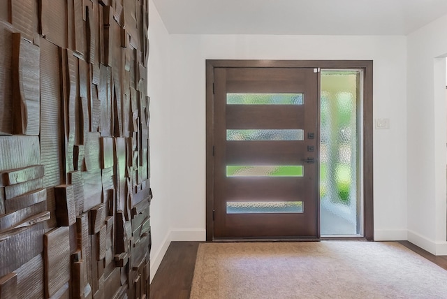 entrance foyer with baseboards and wood finished floors