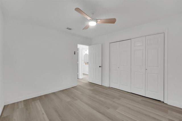 unfurnished bedroom with a ceiling fan, visible vents, baseboards, a closet, and light wood-type flooring