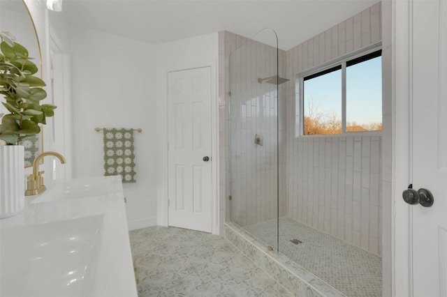 bathroom with tile patterned flooring, a walk in shower, and a sink