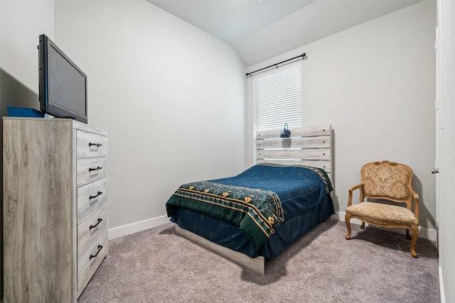 bedroom featuring light carpet, baseboards, and lofted ceiling