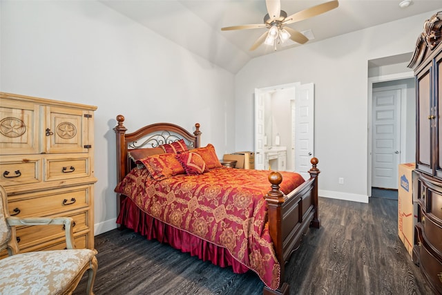 bedroom with baseboards, dark wood finished floors, a ceiling fan, ensuite bathroom, and vaulted ceiling