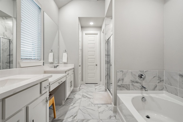 bathroom with marble finish floor, a stall shower, a garden tub, and vanity