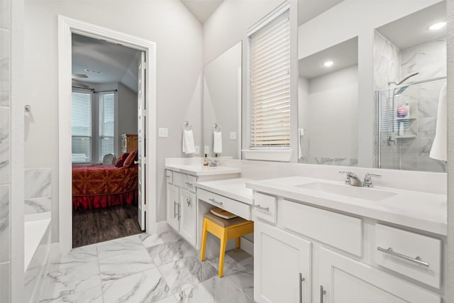 bathroom featuring ensuite bathroom, a sink, marble finish floor, a shower stall, and double vanity