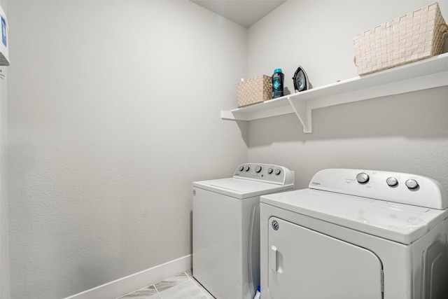 laundry room featuring laundry area, baseboards, and washer and clothes dryer