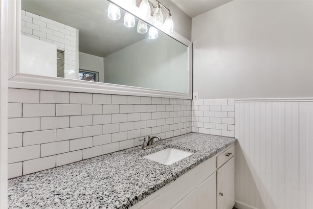 bathroom with vanity and tasteful backsplash