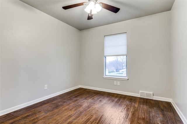 empty room with ceiling fan and dark hardwood / wood-style floors