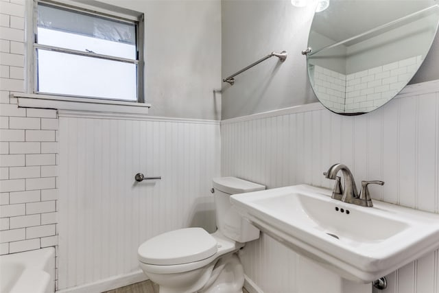 full bathroom with sink,  shower combination, and toilet