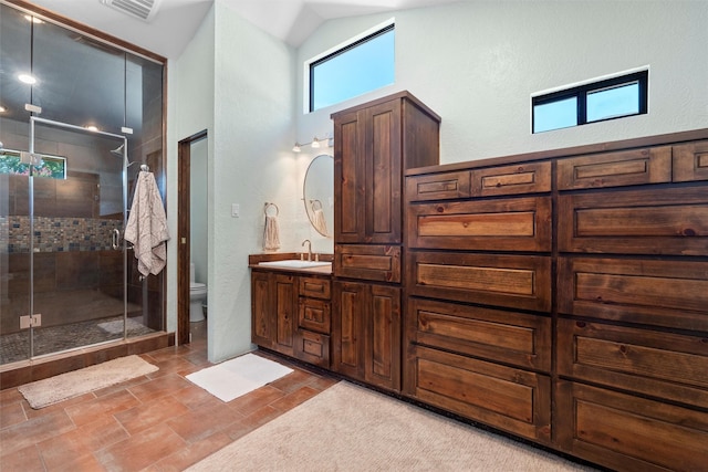 bathroom featuring high vaulted ceiling, vanity, toilet, and a shower with door