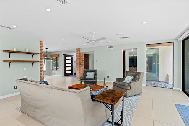 living room with ceiling fan, light tile patterned flooring, and decorative columns