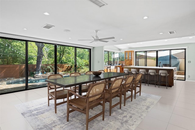 tiled dining area with ceiling fan