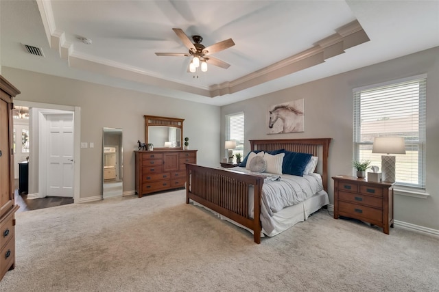 bedroom with visible vents, baseboards, light colored carpet, ornamental molding, and a tray ceiling