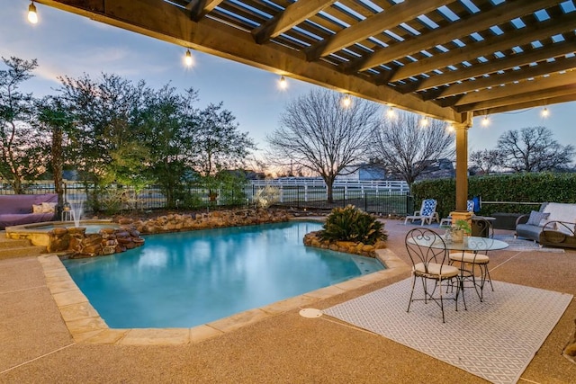 view of pool featuring a patio area, fence, a pool with connected hot tub, and a pergola