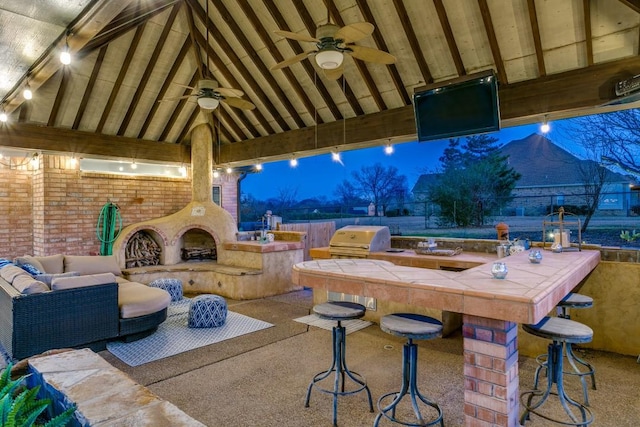 view of patio featuring outdoor wet bar, a ceiling fan, area for grilling, grilling area, and a gazebo