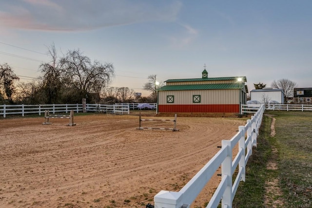 view of yard with fence, an enclosed area, and a rural view