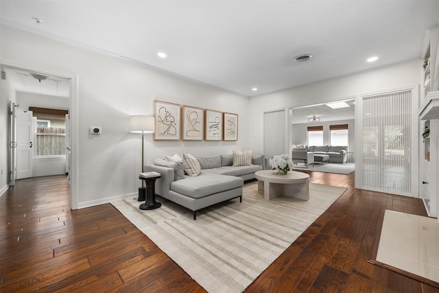 living room with hardwood / wood-style flooring and crown molding