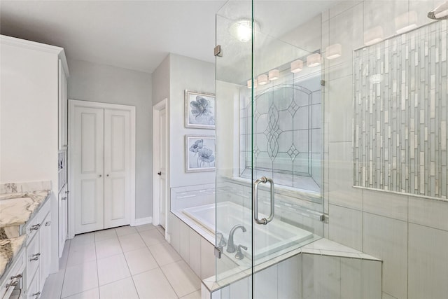 bathroom featuring shower with separate bathtub, tile patterned flooring, and vanity