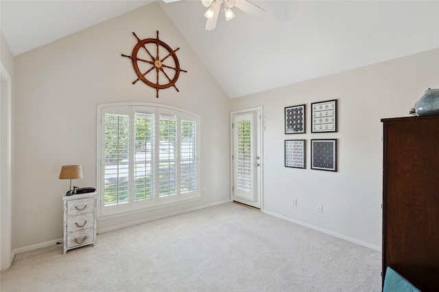 interior space featuring light carpet, high vaulted ceiling, access to outside, and ceiling fan