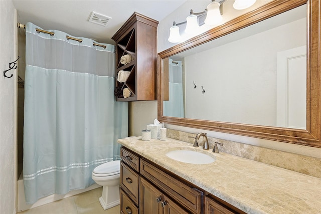 bathroom with toilet, tile patterned flooring, vanity, and walk in shower