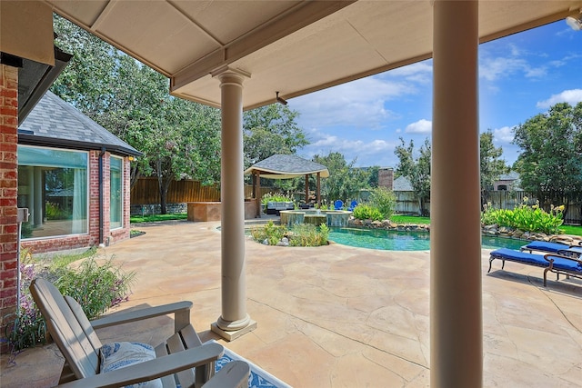 view of patio featuring a gazebo and a pool with hot tub