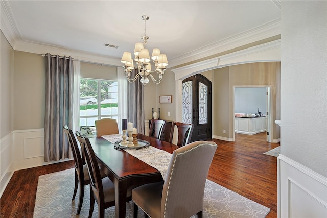 dining area featuring a chandelier, dark hardwood / wood-style flooring, french doors, and ornamental molding