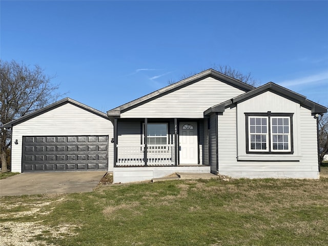 single story home featuring covered porch, a garage, and a front yard