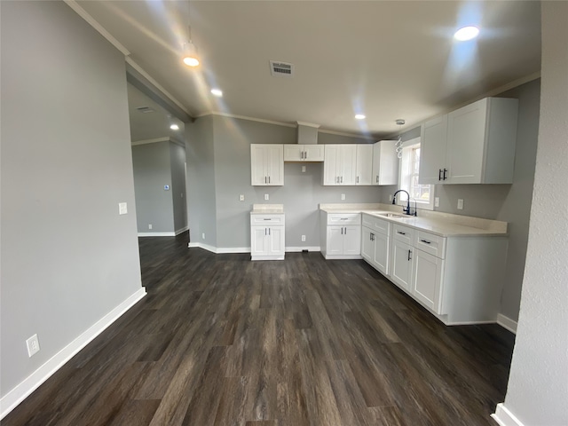 207 County Road 2005, Corsicana, TX 75110 - kitchen with dark hardwood / wood-style flooring, sink, crown molding, and white cabinets