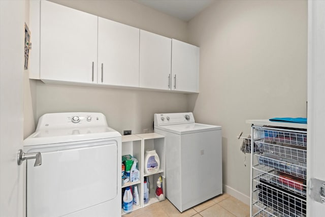 2123 Albany St, Dallas, TX 75201 - laundry area with cabinets, light tile patterned floors, and washer and clothes dryer