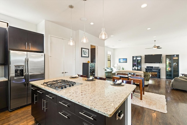 2123 Albany St, Dallas, TX 75201 - kitchen featuring dark brown cabinets, stainless steel appliances, decorative light fixtures, a center island, and dark hardwood / wood-style floors