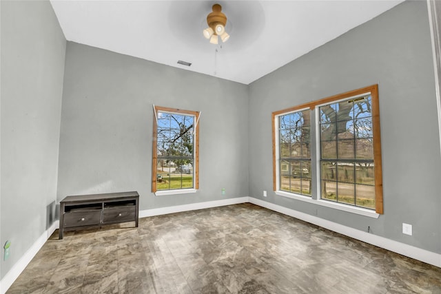 empty room with plenty of natural light, baseboards, and ceiling fan