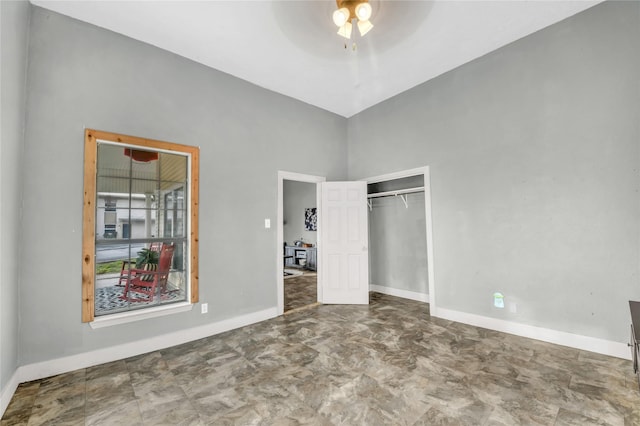 unfurnished bedroom featuring a closet, baseboards, and ceiling fan