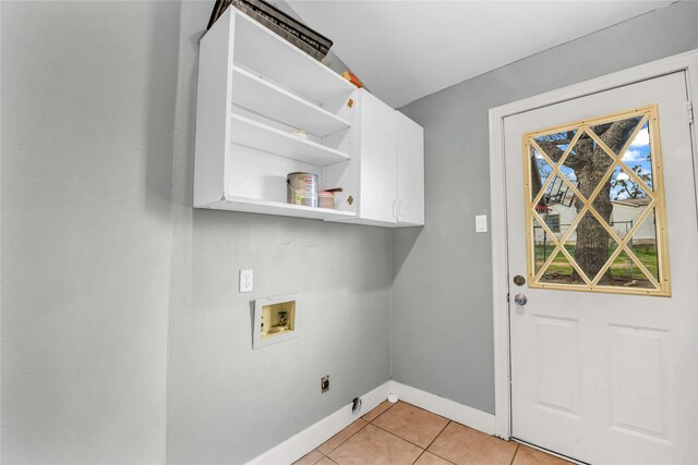 laundry area with light tile patterned floors, washer hookup, baseboards, cabinet space, and electric dryer hookup