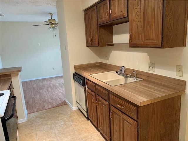 kitchen with range, stainless steel dishwasher, ceiling fan, light tile patterned flooring, and sink