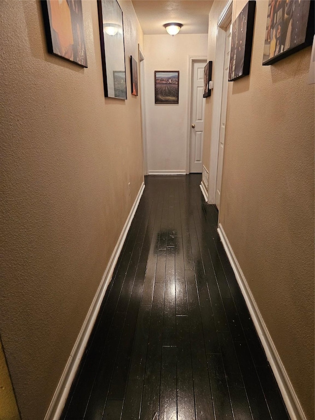 corridor featuring dark hardwood / wood-style flooring