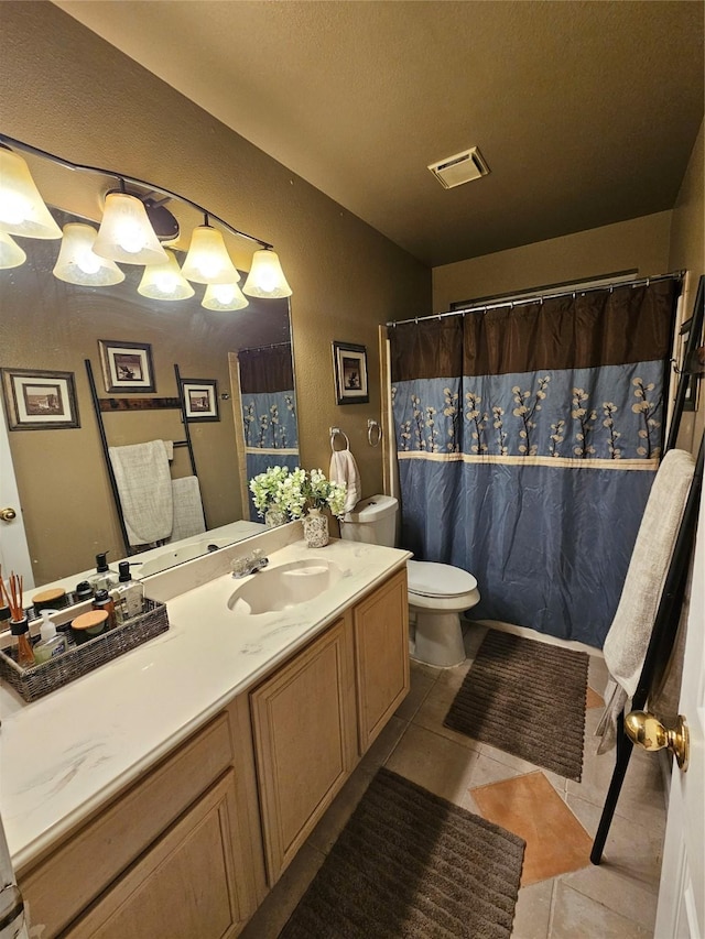 bathroom featuring tile patterned floors, toilet, and vanity