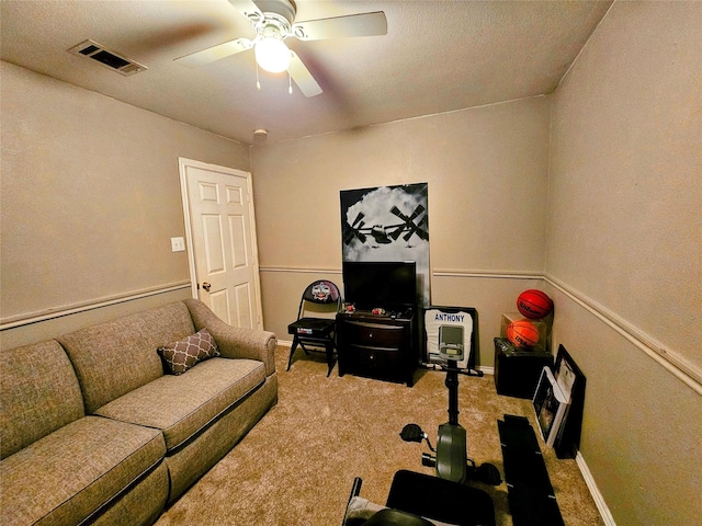 carpeted living room with ceiling fan