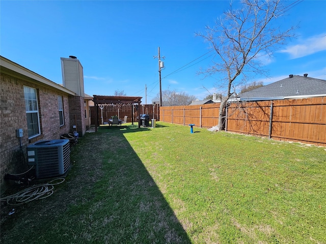 view of yard featuring central AC and a pergola