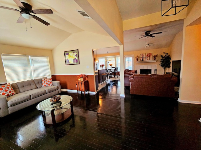 living room with lofted ceiling, dark hardwood / wood-style floors, and ceiling fan