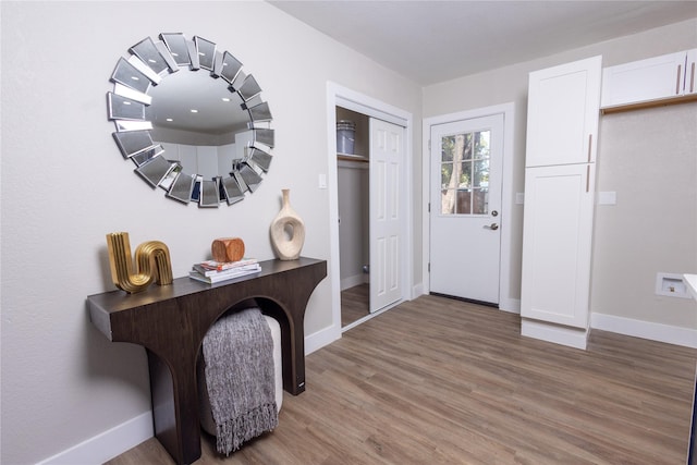 entryway featuring light wood-style floors and baseboards