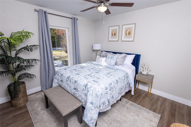 bedroom featuring a ceiling fan, baseboards, and wood finished floors