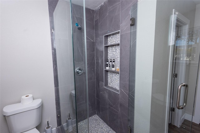 full bath with a stall shower and toilet