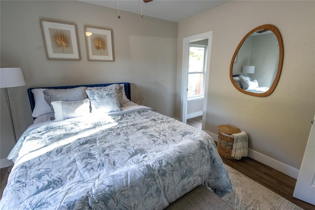 bedroom featuring baseboards and wood finished floors