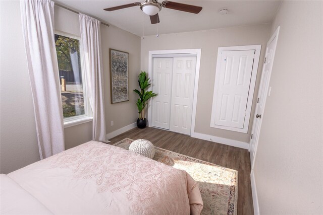 bedroom featuring a closet, ceiling fan, baseboards, and wood finished floors