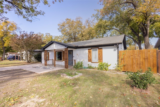 view of front of home with a front yard and fence