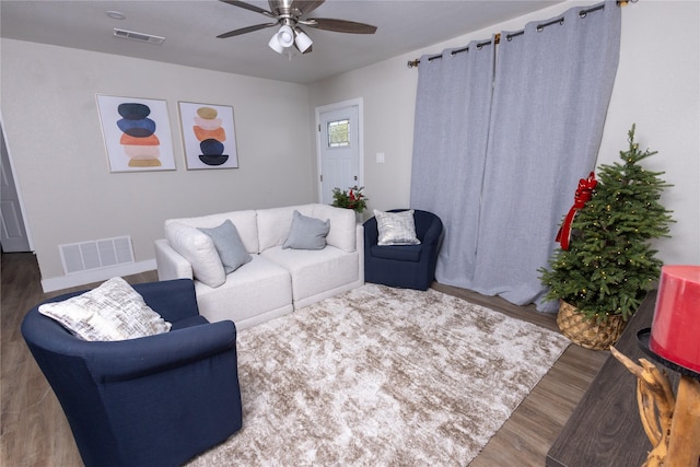 living area with ceiling fan, wood finished floors, and visible vents