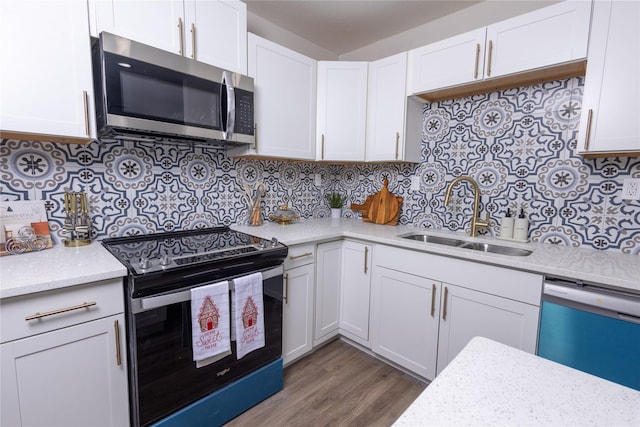 kitchen featuring range with electric stovetop, a sink, decorative backsplash, dishwasher, and stainless steel microwave