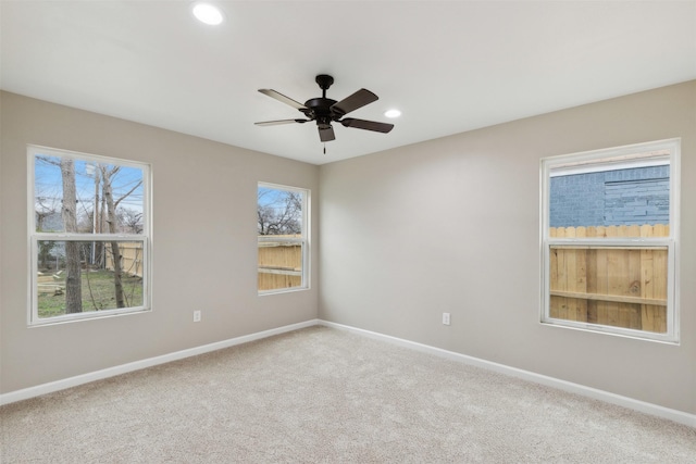 empty room featuring recessed lighting, carpet, a ceiling fan, and baseboards